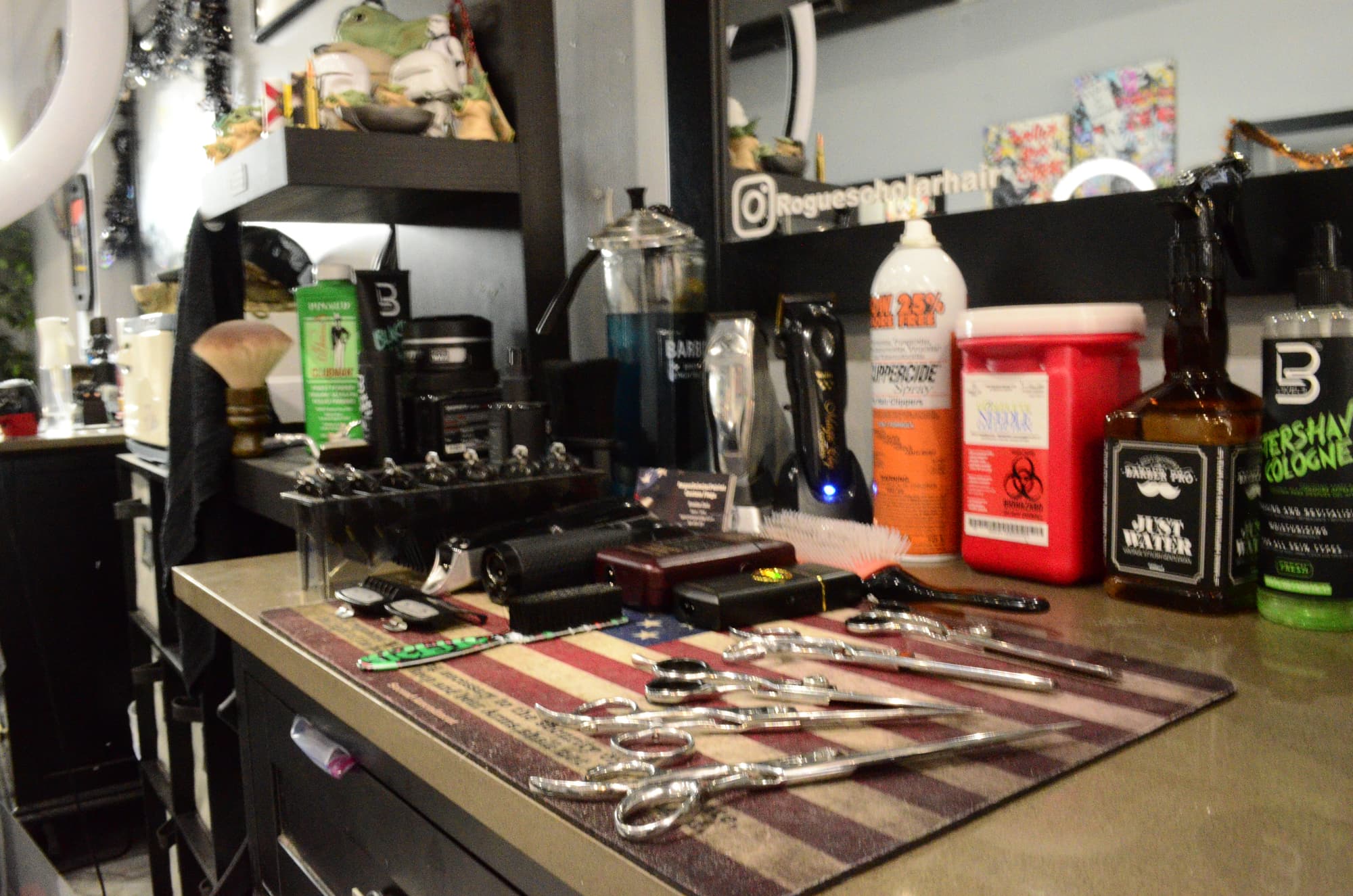 A Legacy barber station laid out with shears, clippers and tonics